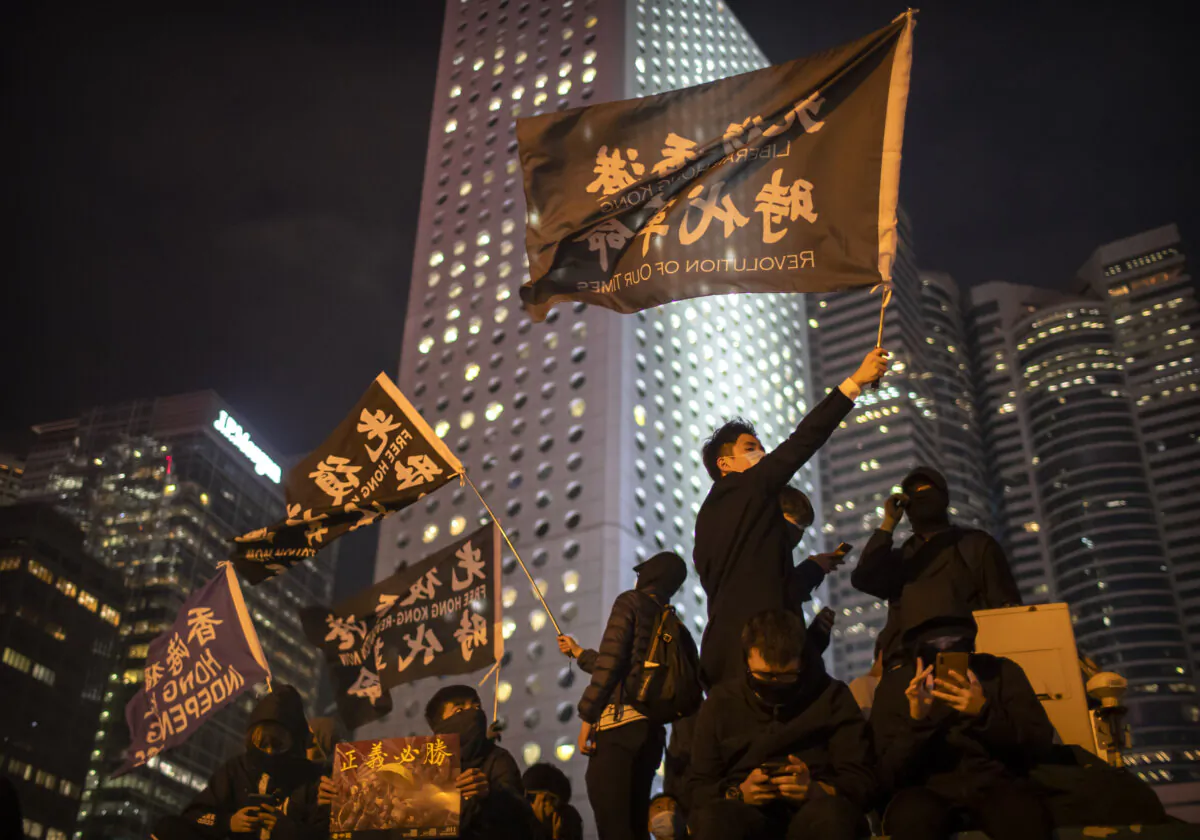 A protestor holds a flag that reads: "Liberate Hong Kong, Revolution of Our Times" at a rally in Hong Kong, on Dec. 12, 2019. (Mark Schiefelbein/AP Photo)
