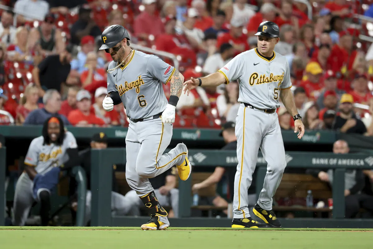 Pittsburgh Pirates' Yasmani Grandal, left, is congratulated by third base coach Mike Rabelo, right, as he runs the bases after hitting a solo home run during the seventh inning against the St. Louis Cardinals in St. Louis, on Sept. 19, 2024. (Scott Kane/AP Photo)