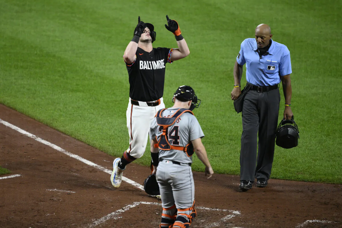 Baltimore Orioles' James McCann gestures as he celebrates his home run in front of Detroit Tigers catcher Jake Rogers (34) and home plate umpire CB Bucknor, right, during the sixth inning of a baseball game in Baltimore, on Sept. 20, 2024. (Nick Wass/AP Photo)