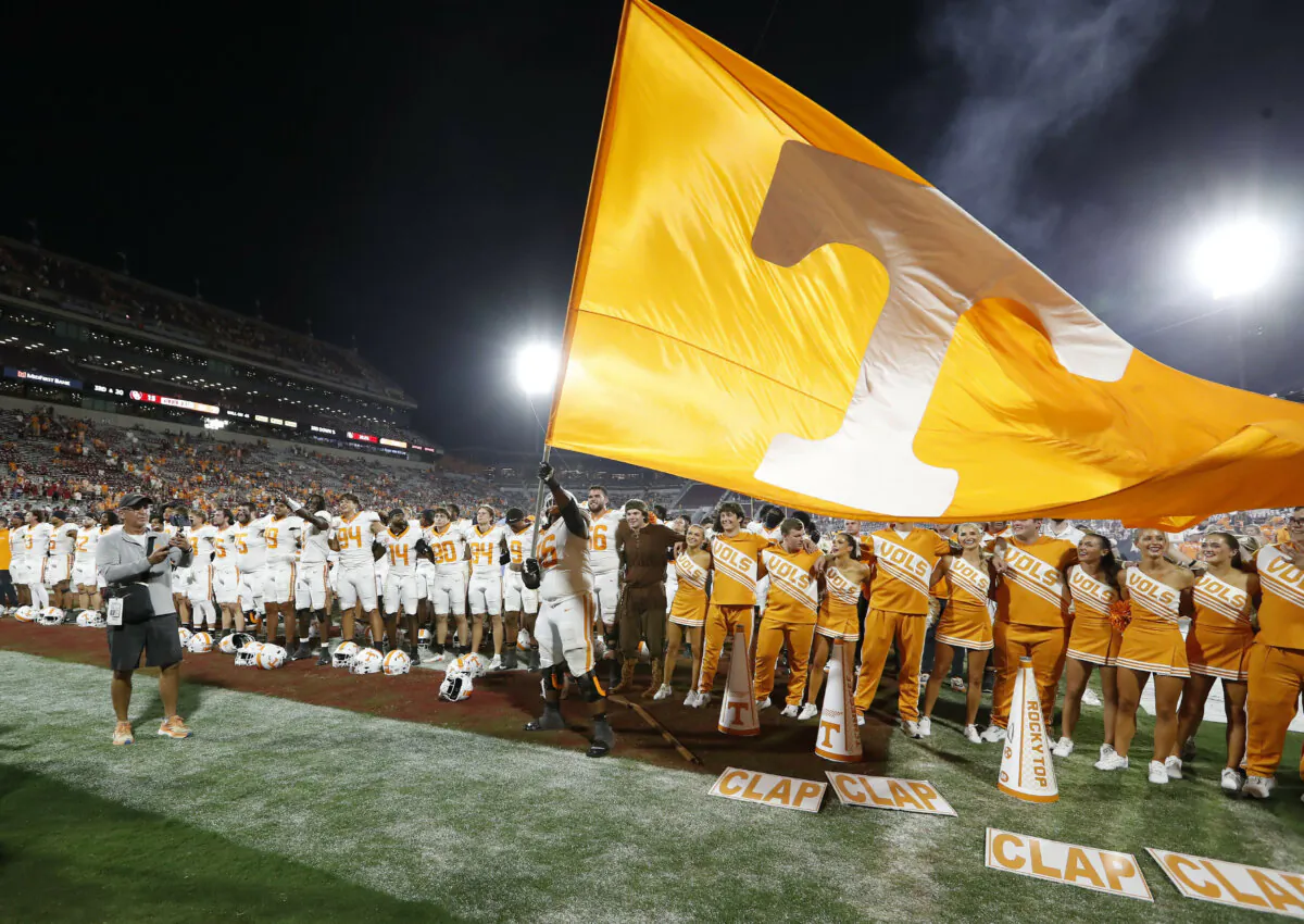 Tennessee offensive lineman Javontez Spraggins (76) waves a giant Tennessee flag after his team defeated Oklahoma in an NCAA college football game, in Norman, Okla., on Sept. 21, 2024. (Alonzo Adams/AP Photo)