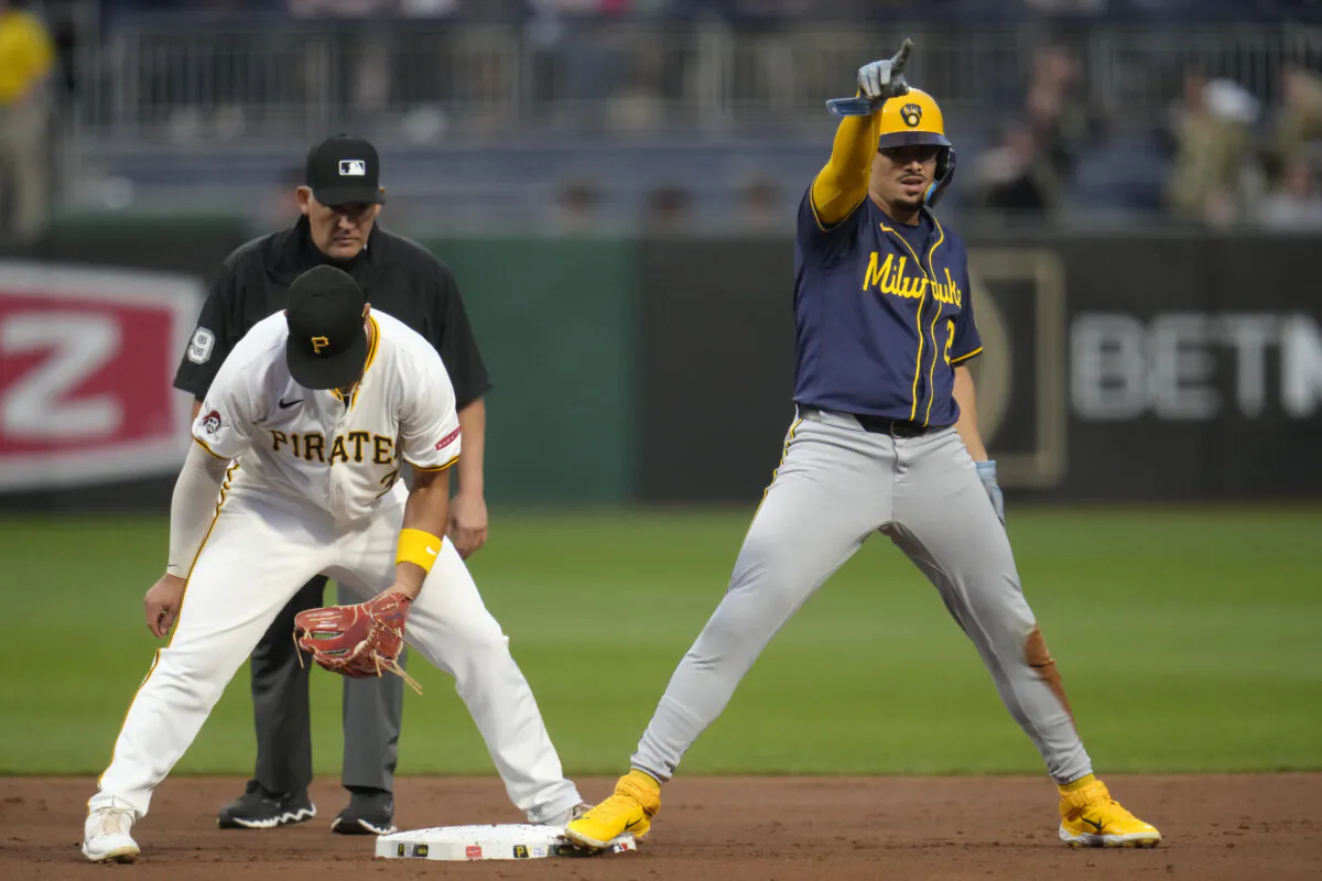 Milwaukee Brewers' Willy Adames, right, celebrates after stealing second base ahead of the tag attempted by Pittsburgh Pirates second baseman Nick Yorke, left, with umpire Manny Gonzales, left rear, making the call during the second inning of a baseball game in Pittsburgh, on Sept. 24, 2024. (Gene J. Puskar/AP Photo)