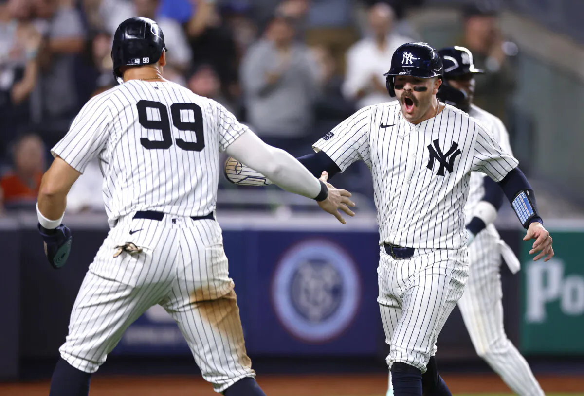 New York Yankees' Aaron Judge (99) and Austin Wells, front right, celebrate after scoring against the Baltimore Orioles during the sixth inning of a baseball game in New York, on Sept. 26, 2024. (Noah K. Murray/AP Photo)