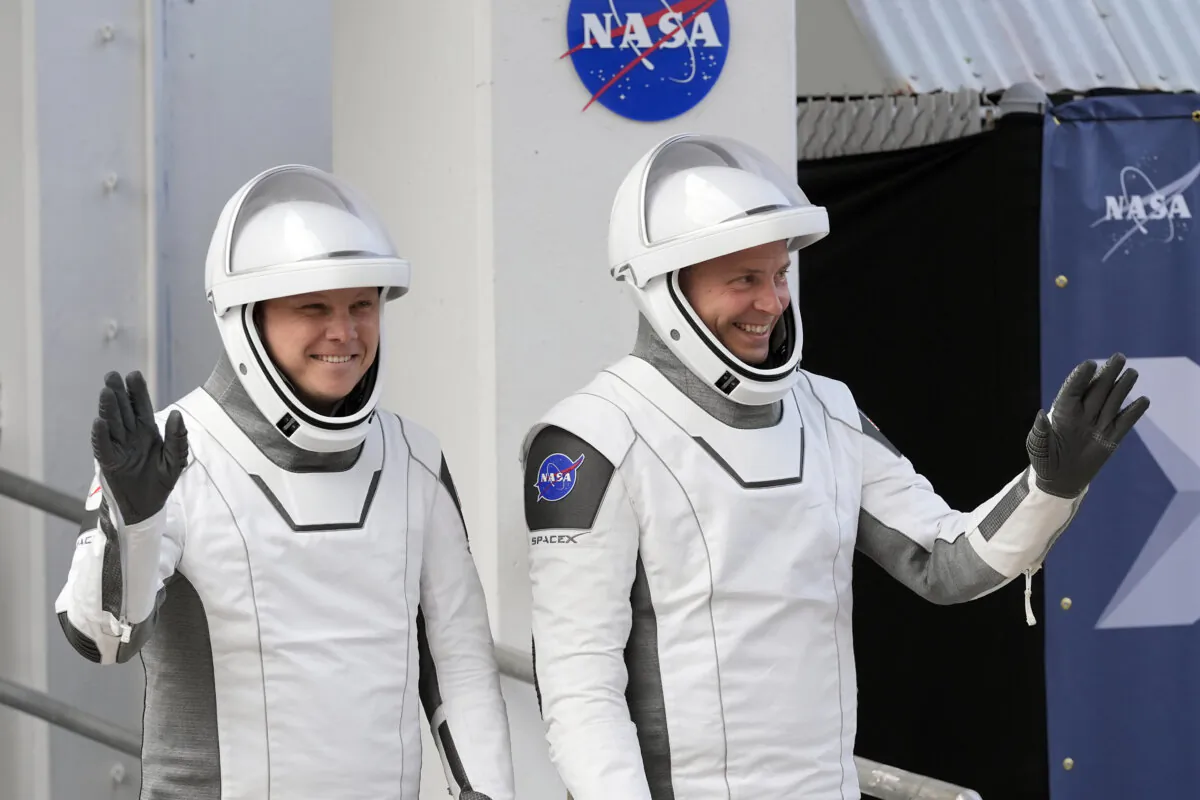Roscosmos cosmonaut Aleksandr Gorbunov (L) and NASA astronaut Nick Hague wave as they leave the Operations and Checkout Building on their way to Launch Complex 40 for a mission to the International Space Station, at Cape Canaveral, Fla., on. Sept. 28, 2024. (John Raoux/AP Photo)
