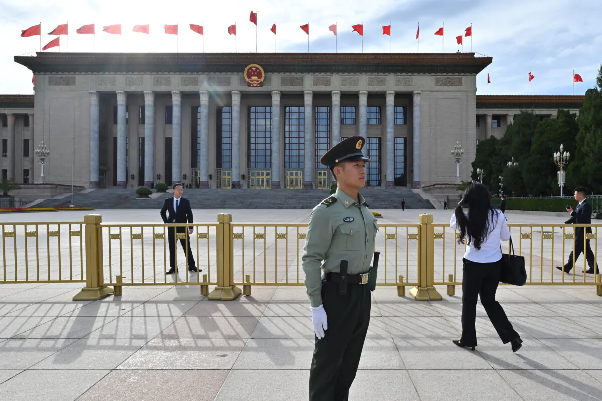 Security officials stand guard outside the Great Hall of the People prior to a reception celebrating the 75th anniversary of the Communist Party rule, in Beijing on Sept. 30, 2024. (Adek Berry/AFP via Getty Images)