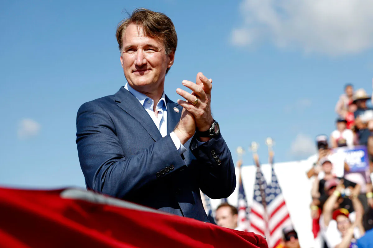 Virginia Gov. Glenn Youngkin listens as Republican presidential nominee former President Donald Trump speaks during a rally at Greenbrier Farms in Chesapeake, Va., on June 28, 2024. (Anna Moneymaker/Getty Images)