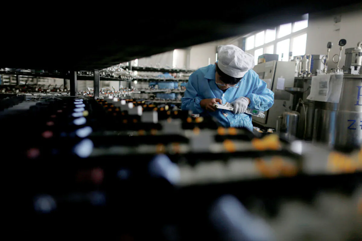 A laborer works inside an electronics factory in Qingdao, Shandong Province, China, on Jan. 29, 2018. (William Hong/Reuters)