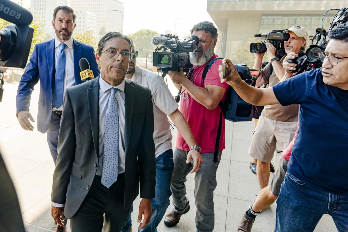 Dr. Mark Chavez, a physician from San Diego (2nd L), who is charged in connection with actor Matthew Perry's death from an accidental ketamine overdose, and his criminal defense attorney, Matthew Binninger (L), arrive for a change of plea hearing at the federal courthouse in Los Angeles on Oct. 2, 2024. (Damian Dovarganes/AP Photo)