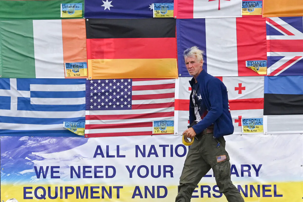 U.S. citizen Ryan Wesley Routh hangs up national flags of countries helping Ukraine in Kyiv, Ukraine, on June 23, 2022. (Sergei Supinsky/AFP via Getty Images)