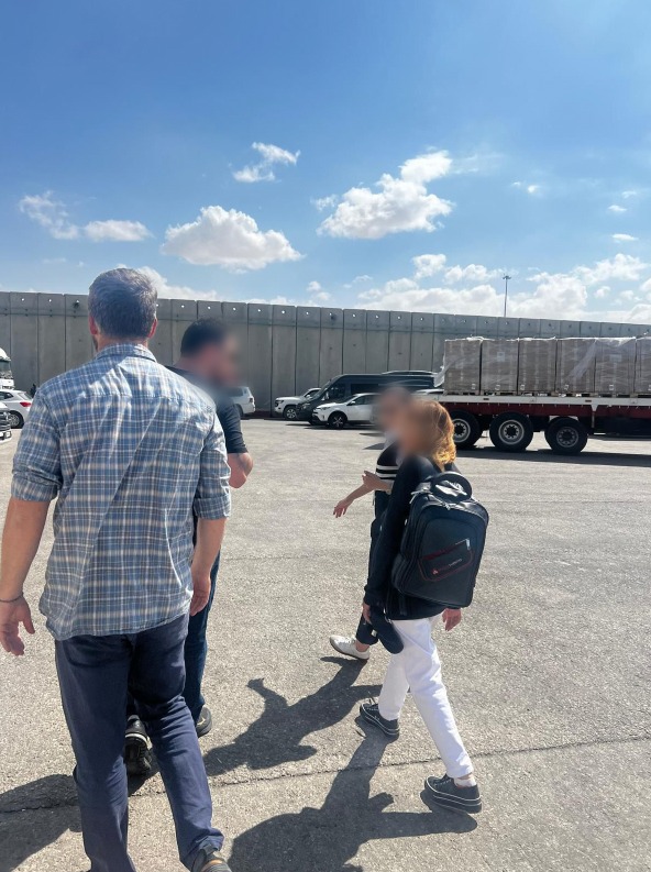 Fawzia Amin Sido (right) seen being taken through the Kerem Shalom crossing after being rescued from Gaza in a photo released on Oct. 3, 2024 (Israel Defense Forces)