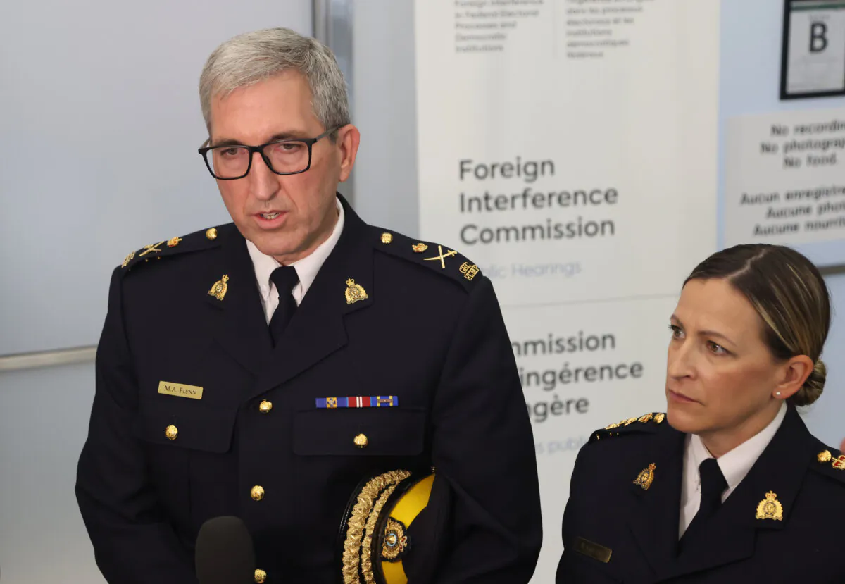 Royal Canadian Mounted Police (RCMP) Deputy Commissioner Mark Flynn (L) and RCMP Assistant Commissioner Brigitte Gauvin speak to reporters after testifying at the Foreign Interference Commission in Ottawa on Oct. 3, 2024. (The Canadian Press/Patrick Doyle)