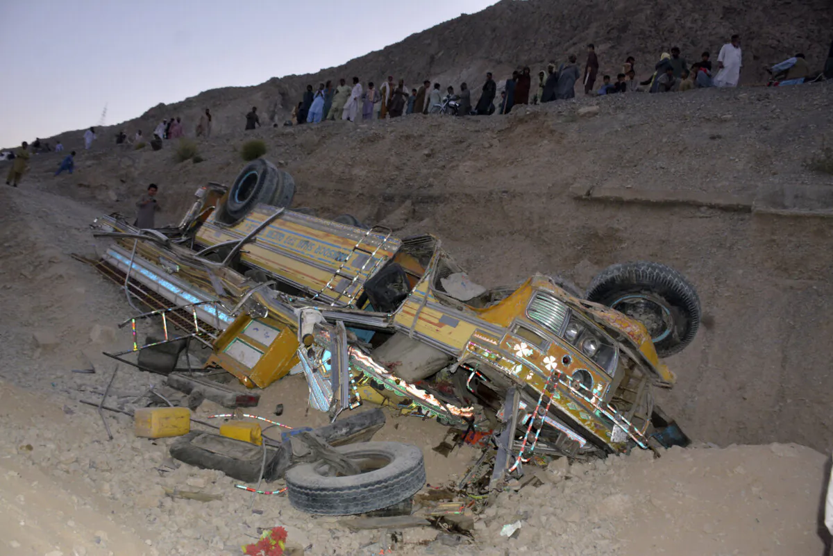 Locals gather near the wreckage of a bus that fell into a ravine near Quetta, the capital of Balochistan province, Pakistan, on Oct. 3, 2024. (Arshad Butt/AP Photo)