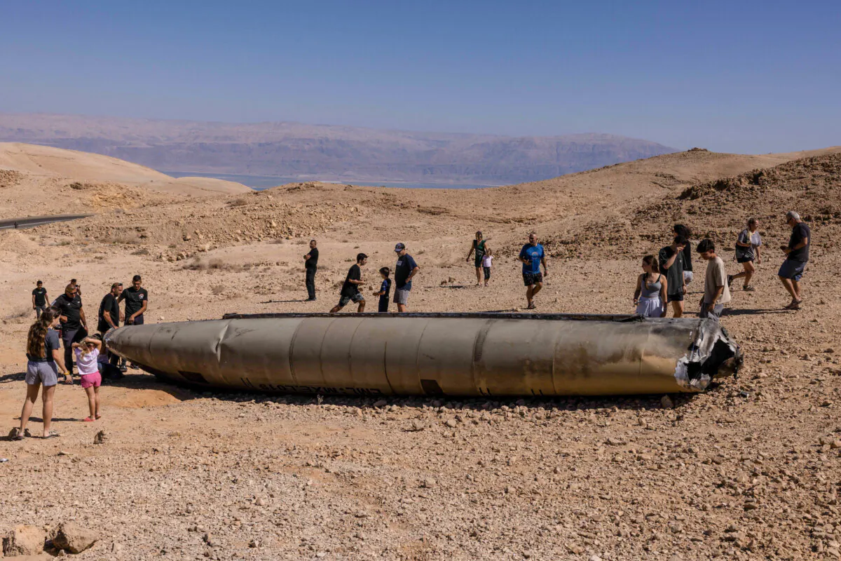 People visit the site of the remains of an Iranian missile in the Negev desert near Arad on Oct. 3, 2024, in the aftermath of an Iranian missile attack on Israel. (MENAHEM KAHANA/AFP via Getty Images)