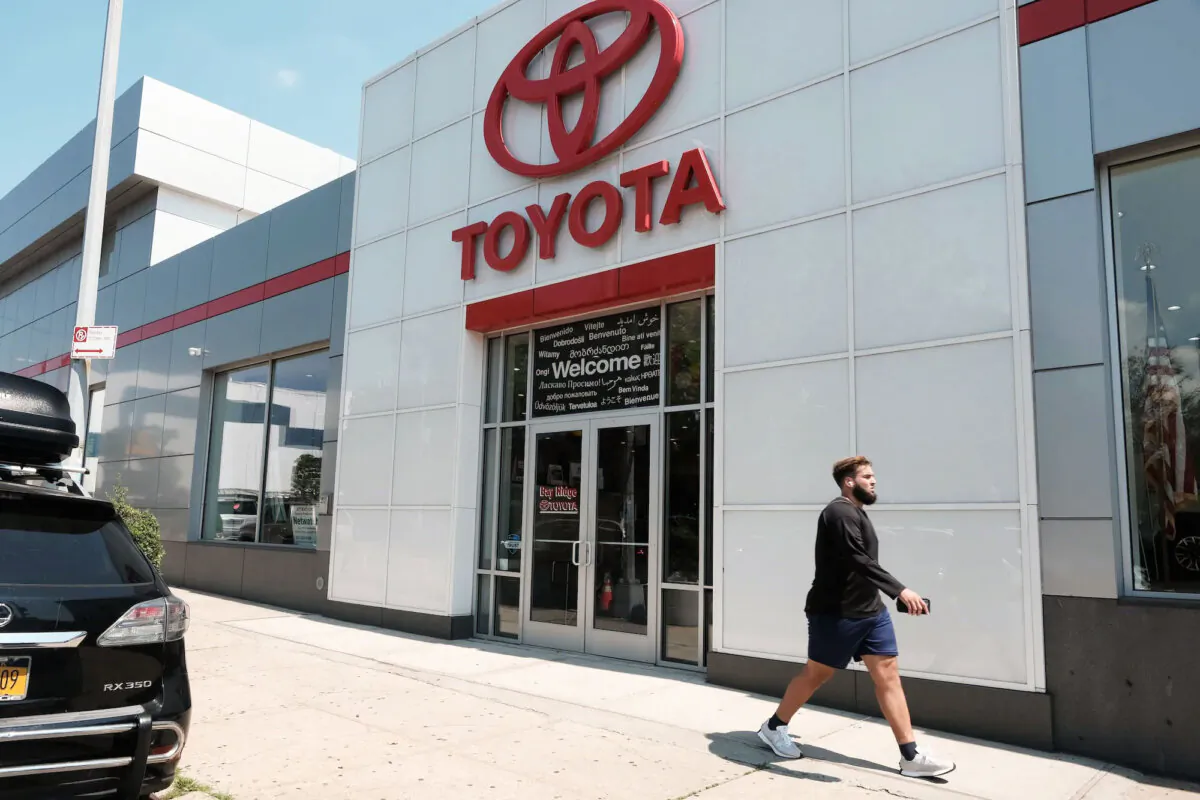 A man walks by a Toyota dealership in Brooklyn, N.Y., on Aug. 04, 2022. (Spencer Platt/Getty Images)