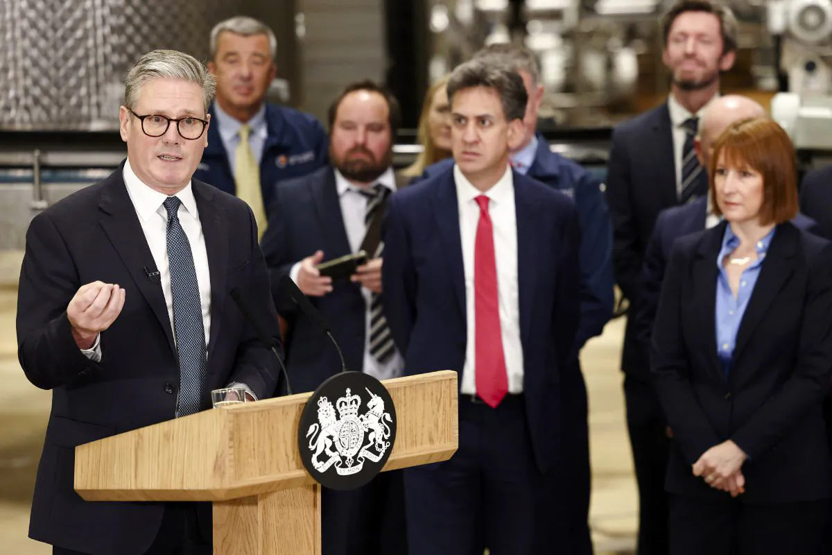 Prime Minister Keir Starmer (L) speaks as Energy Security and Net Zero Secretary Ed Miliband (C) and Chancellor of the Exchequer Rachel Reeves (R) listen during a visit to a manufacturing facility in Chester, England, on Oct. 4, 2024. (Darren Staples/PA Wire)