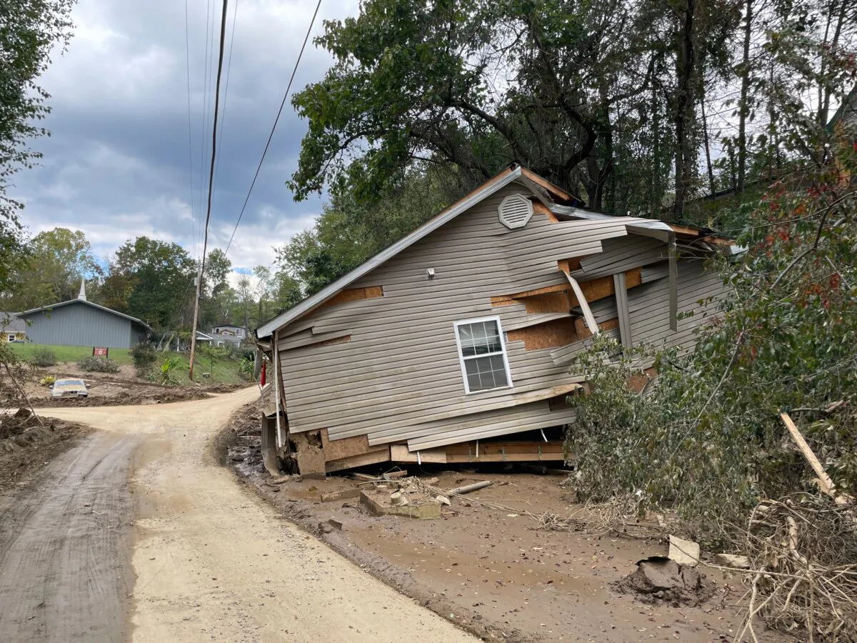 The top level of a three-story home, according to police, off Tunnel Road, Asheville, N.C., on Oct. 3, 2024. The second floor ended up on the Tunnel Road Bridge 200 yards away, and the ground floor came to a rest at a gas station a little farther on. (Richard Moore/The Epoch Times)
