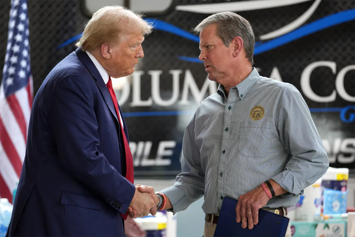 Republican presidential nominee former President Donald Trump (L) shakes hands with Georgia Gov. Brian Kemp after speaking at a temporary relief shelter as he visits areas impacted by Hurricane Helene in Evans, Ga., on Oct. 4, 2024. (Evan Vucci/AP Photo)