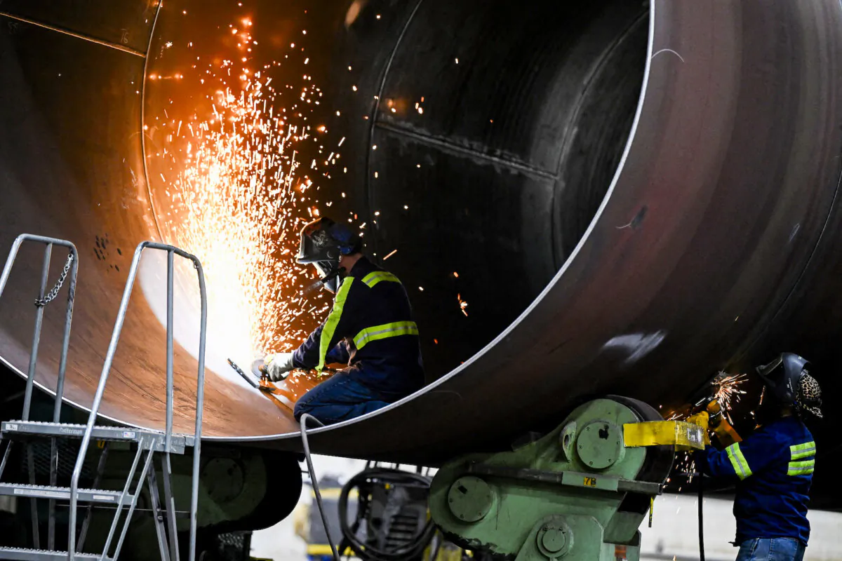 Men work on a wind turbine at a manufacturing plant in Pueblo, Colo., on Nov. 29, 2023. (Andrew Caballero-Reynolds/AFP/Getty Images)
