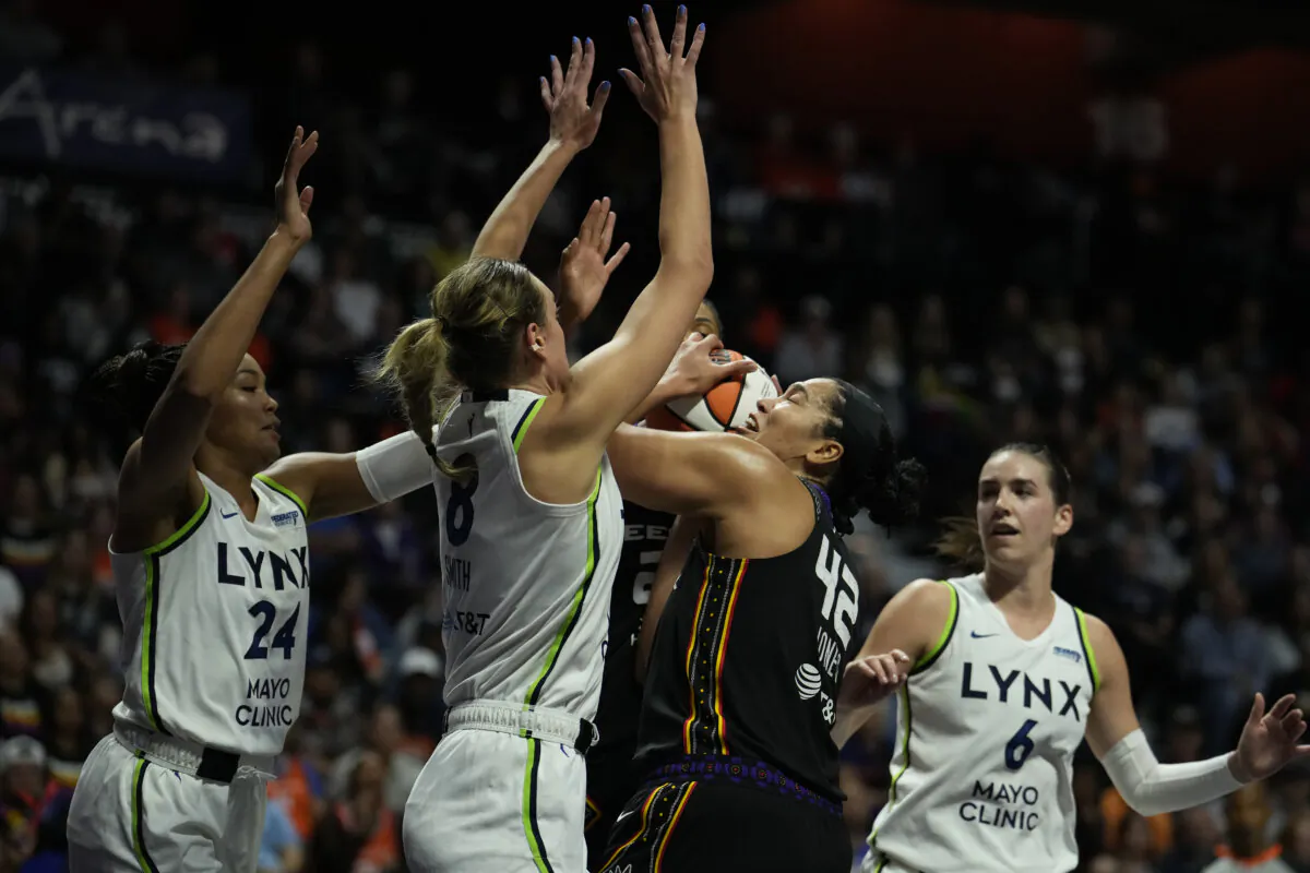 Brionna Jones #42 of the Connecticut Sun is swarmed by Napheesa Collier #24, Alanna Smith #8 and Bridget Carleton #6 of the Minnesota Lynx during the first half of Game Three of the WNBA playoff semifinals at Mohegan Sun Arena in Uncasville, Connecticut, on October 4, 2024. (Joe Buglewicz/Getty Images)