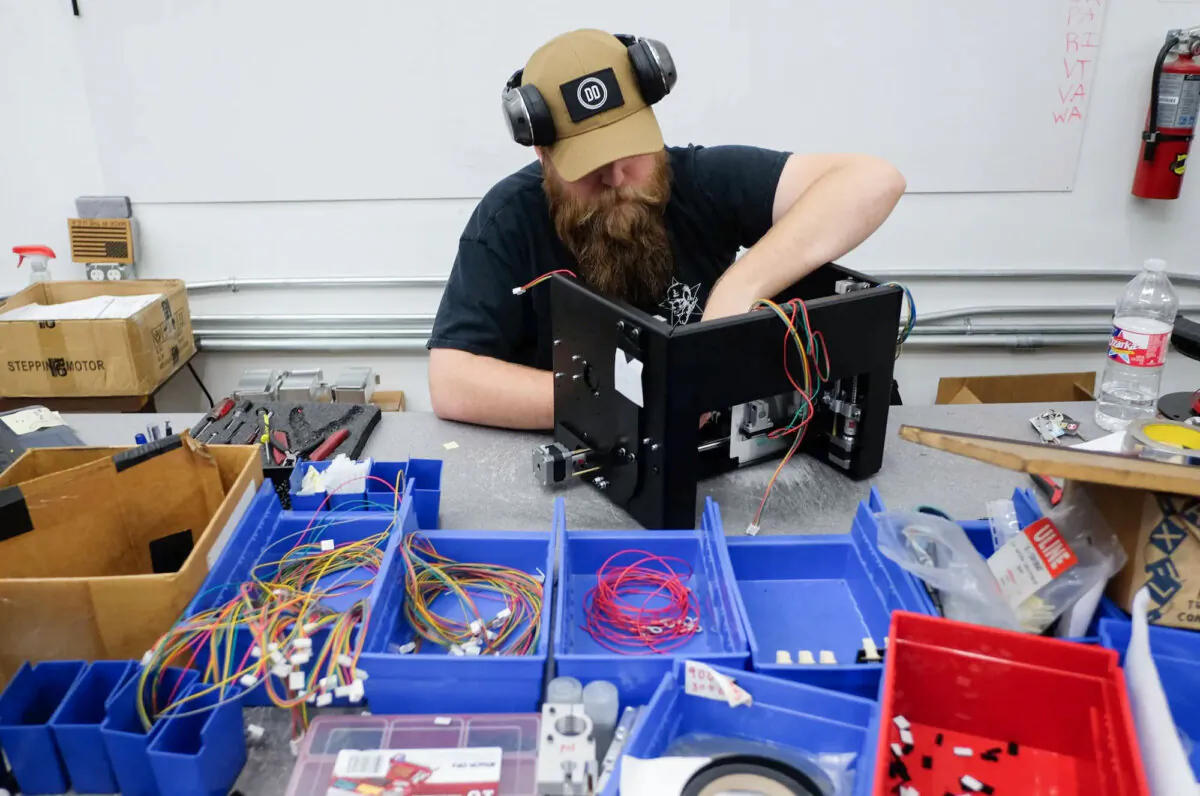An employee installs an electronic package for a Ghost Gunner milling machine at the Defense Distributed factory in Austin, Texas, on Aug. 1, 2018. (Kelly West/AFP/Getty Images)