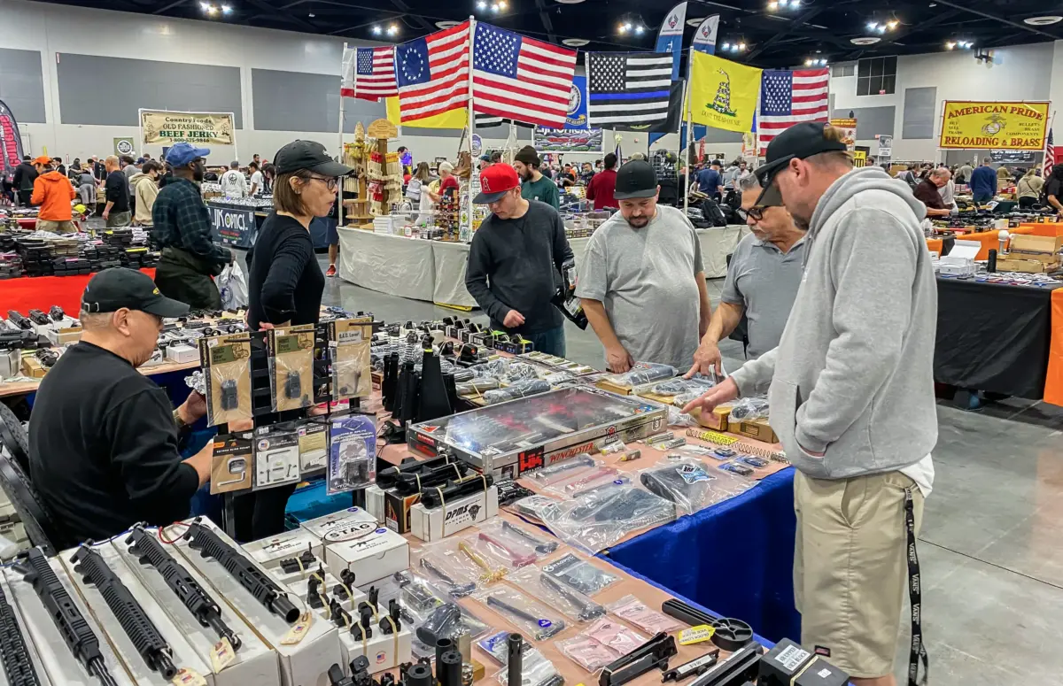 Men browse as vendors sell firearms and accessories at the Crossroads of the West Gun Show at the Convention Center in Ontario, California, on January 28, 2023. (Ap