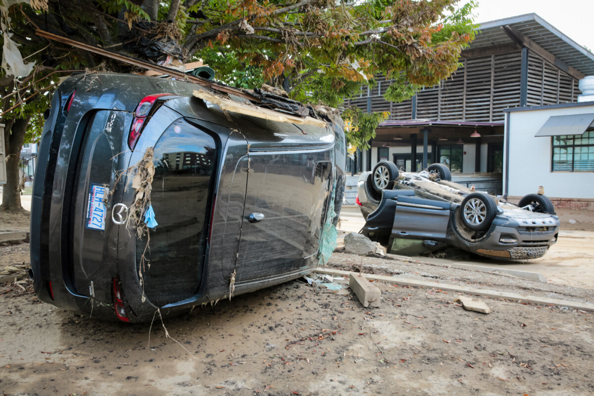 Overturned cars in Biltmore Village, Asheville, N.C., on Oct. 3, 2024. (Richard Moore/The Epoch Times)