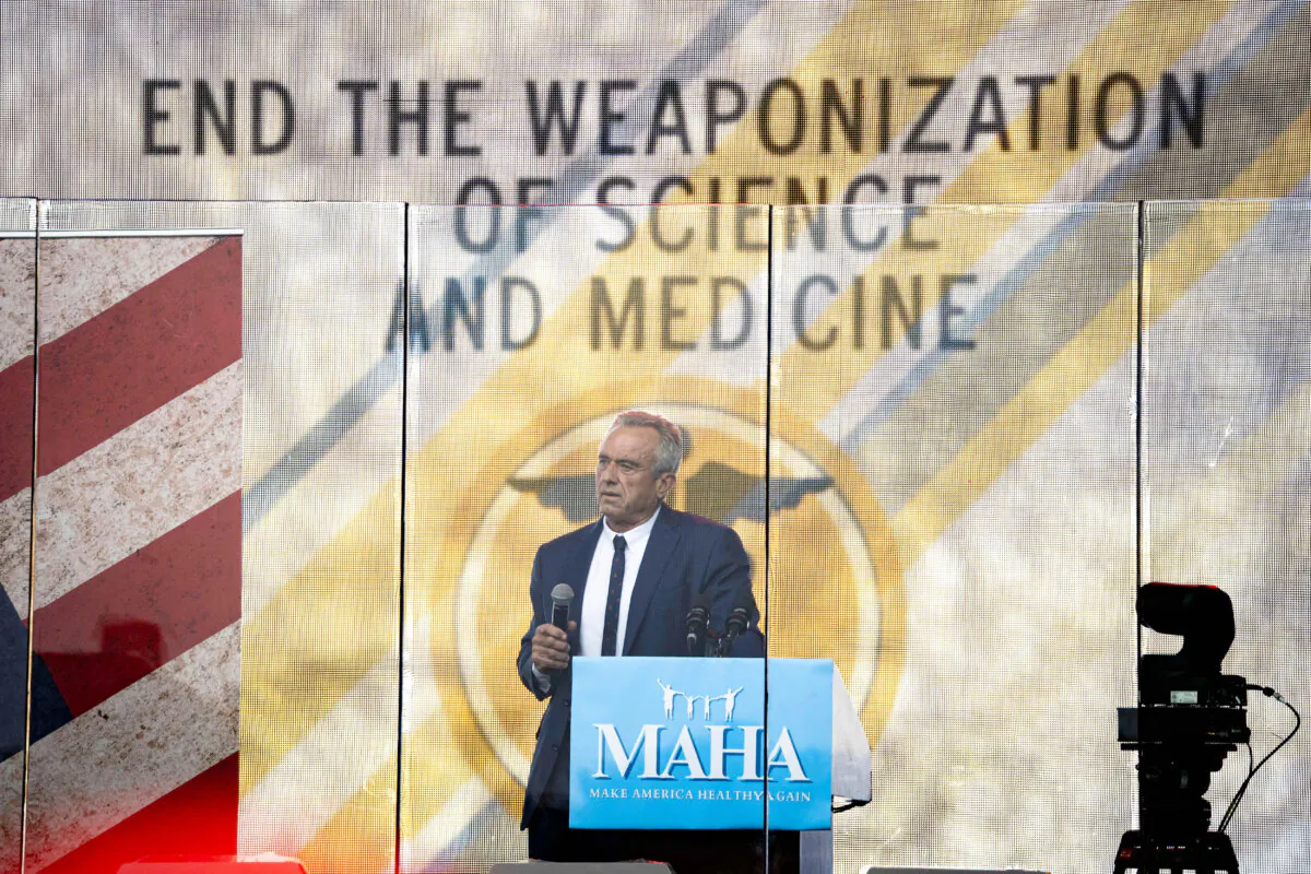 Robert F. Kennedy Jr. speaks behind a bullet proof glass during the Rescue the Republic rally in Washington on Sept. 29, 2024.(Madalina Vasiliu/The Epoch Times)