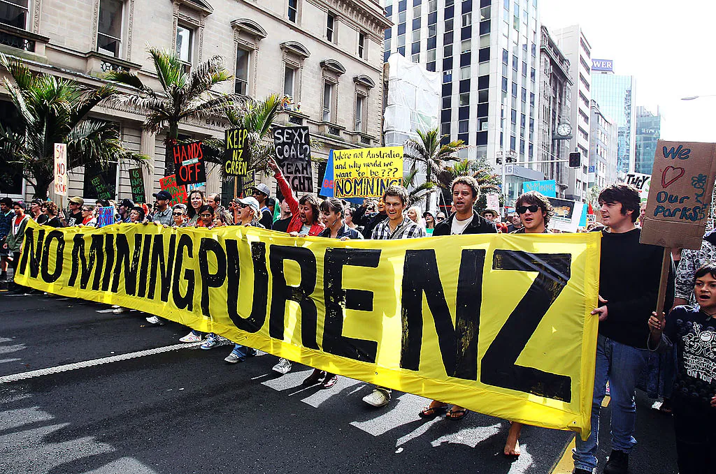 AUCKLAND, NEW ZEALAND - MAY 01:  Protesters march against Mining up Queen Street on May 1, 2010 in Auckland, New Zealand. The New Zealand Government is proposing to open up more than 7000 hectares of conservation land for mining on Coromandel, Paparoa and Stewart Island.  (Photo by Hannah Peters/Getty Images)
