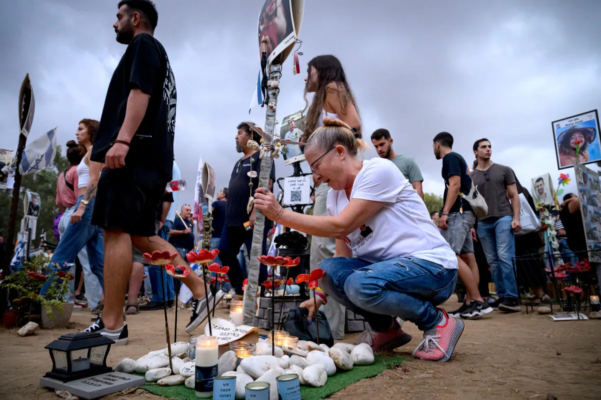 A woman breaks down at the memorial to Amit Magnezi as family members and friends of the lost and kidnapped gather at the site of the Nova Festival to mark the one year anniversary of the attacks by Hamas, in Re'im, Israel, on Oct. 7, 2024. (Leon Neal/Getty Images)