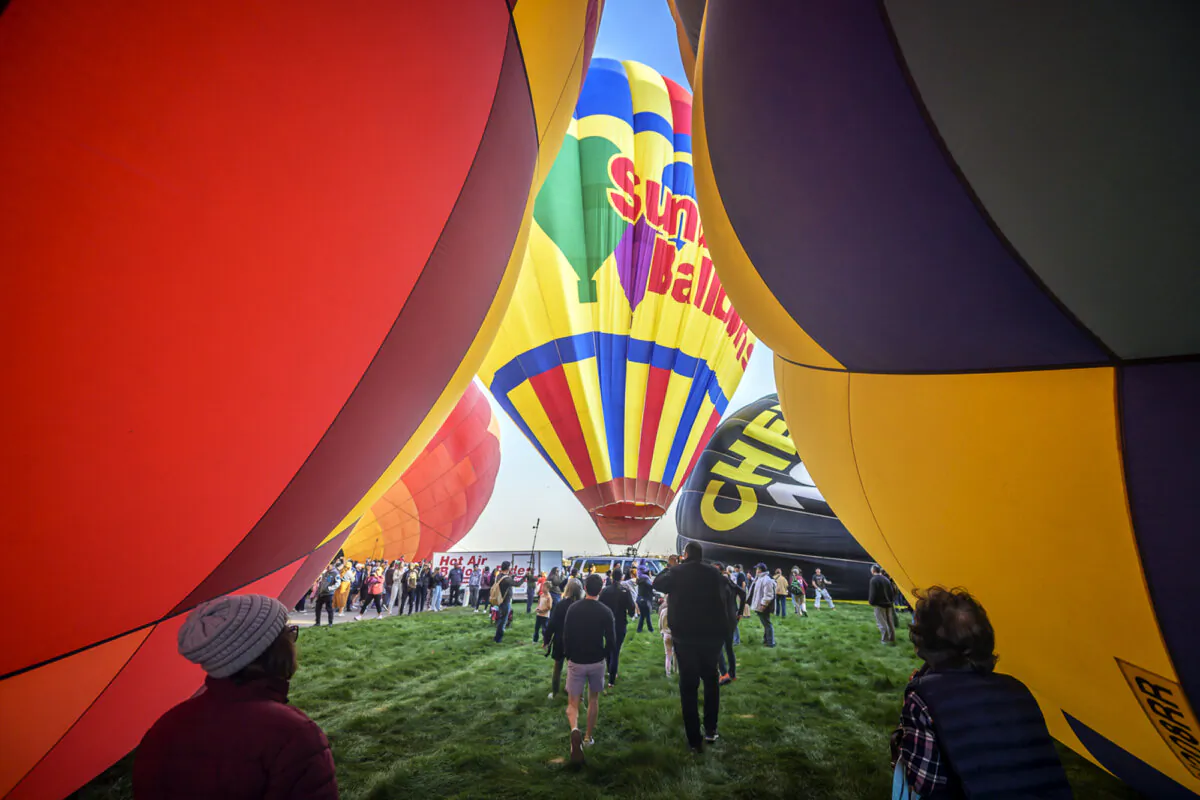 Spectators watch as hot air balloons take off during the mass ascension at the 52nd Albuquerque International Balloon Fiesta in Albuquerque, N.M., on Oct. 5, 2024. (Roberto E. Rosales/AP Photo)