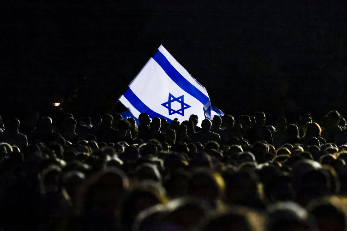 Members of the Australian Jewish community hold an Israeli flag during a memorial service in Sydney, Australia, on Oct. 7, 2024, to mark the anniversary of Palestinian militant group Hamas's Oct. 7, 2023 attack on Israel. (David Gray/AFP via Getty Images)