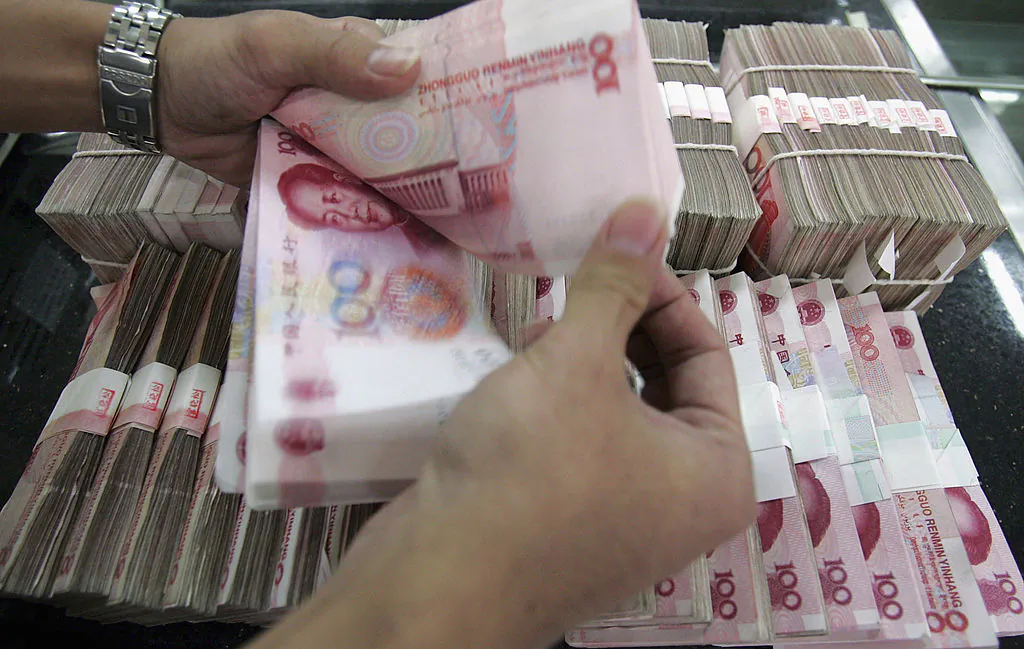 A clerk counts stacks of Chinese yuan at a bank, in this undated file photo. (China Photos/Getty Images)