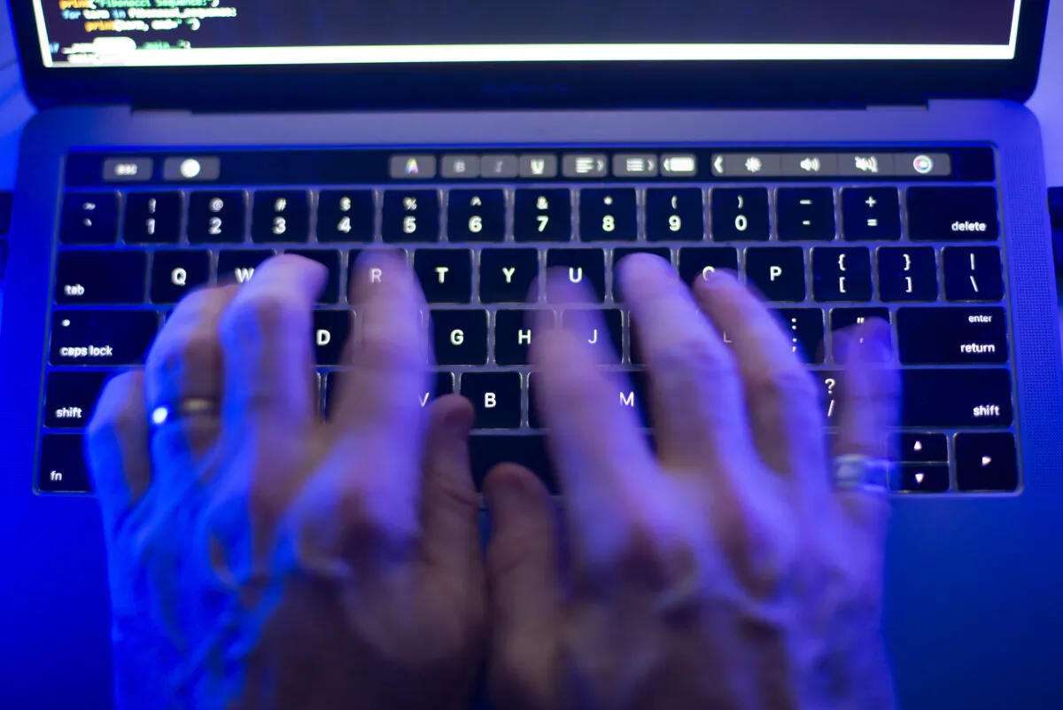 A person types on a computer keyboard in Toronto on Oct. 9, 2023 in this file photo. (The Canadian Press/Graeme Roy)