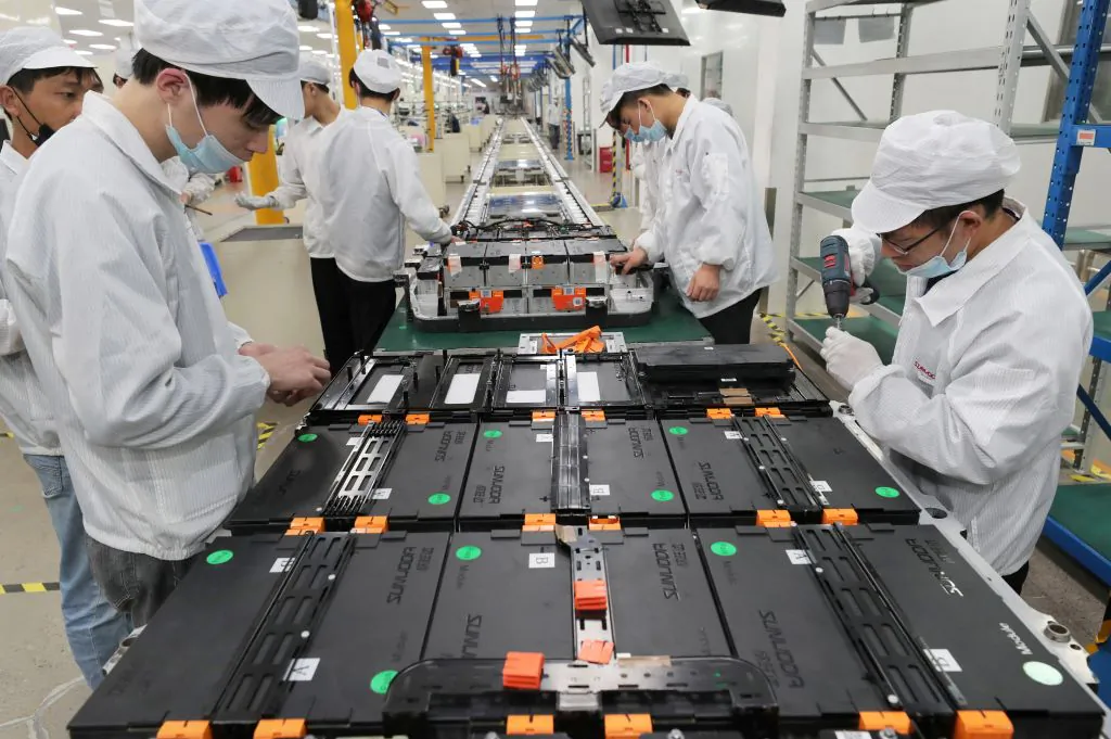 Workers at a factory that makes lithium batteries for electric cars and other uses, in Nanjing, eastern Jiangsu Province, China, on March 12, 2021. (STR/AFP via Getty Images)