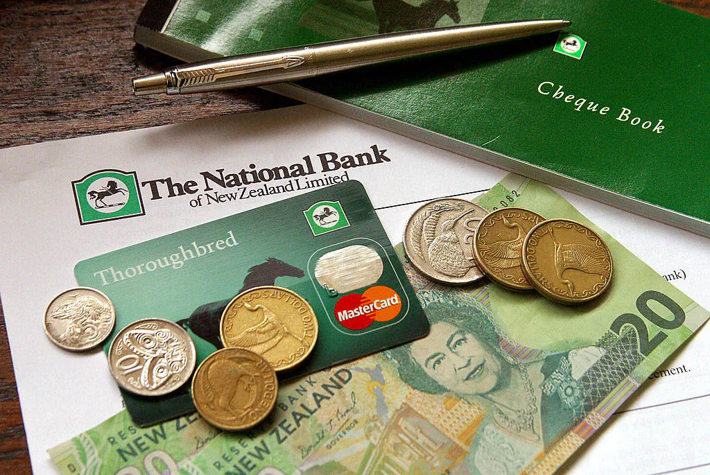 A National Bank of New Zealand MasterCard sits amongst New Zealand currency in Auckland on Oct. 8, 2003. (Dean Treml/AFP via Getty Images)