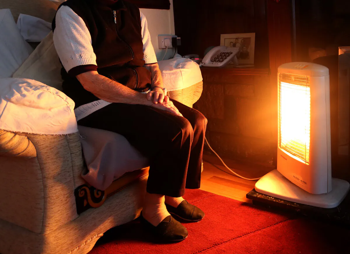 A an elderly lady sitting at home in Liverpool with her electric fire on Nov. 19. 2014. (Peter Byrne/PA)