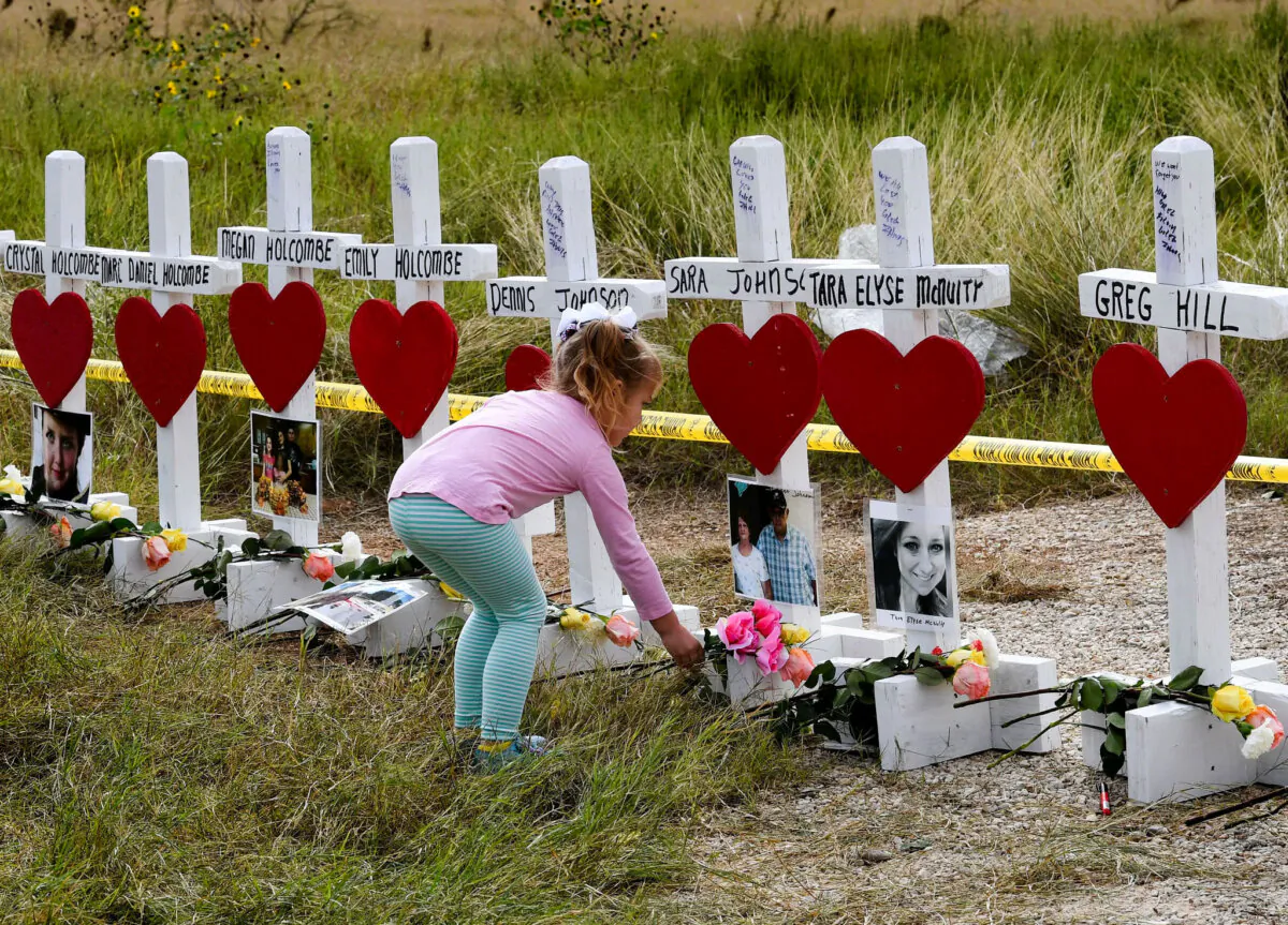 Shaelyn Gisler, 4, leaves flowers on crosses named for victims, outside the First Baptist Church in Sutherland Springs, Texas, on Nov. 9, 2017. The church was the scene of a shooting that killed 26 people.
(Mark Ralston/AFP via Getty Images)