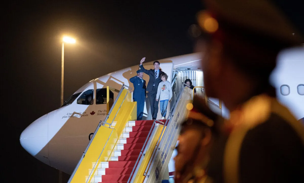Prime Minister Justin Trudeau and his son Hadrien arrive at the airport, in Vientiane, Laos, on Oct. 9, 2024. (The Canadian Press/Adrian Wyld)