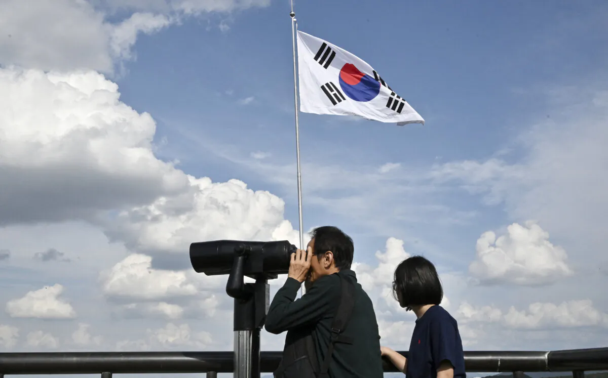 Visitors use binoculars to look at the North Korean side of the Demilitarised Zone dividing the two Koreas, from South Korea's Odusan Unification Observatory in Paju, South Korea, on Oct. 9, 2024. (Jung Yeon-Je/AFP via Getty Images)