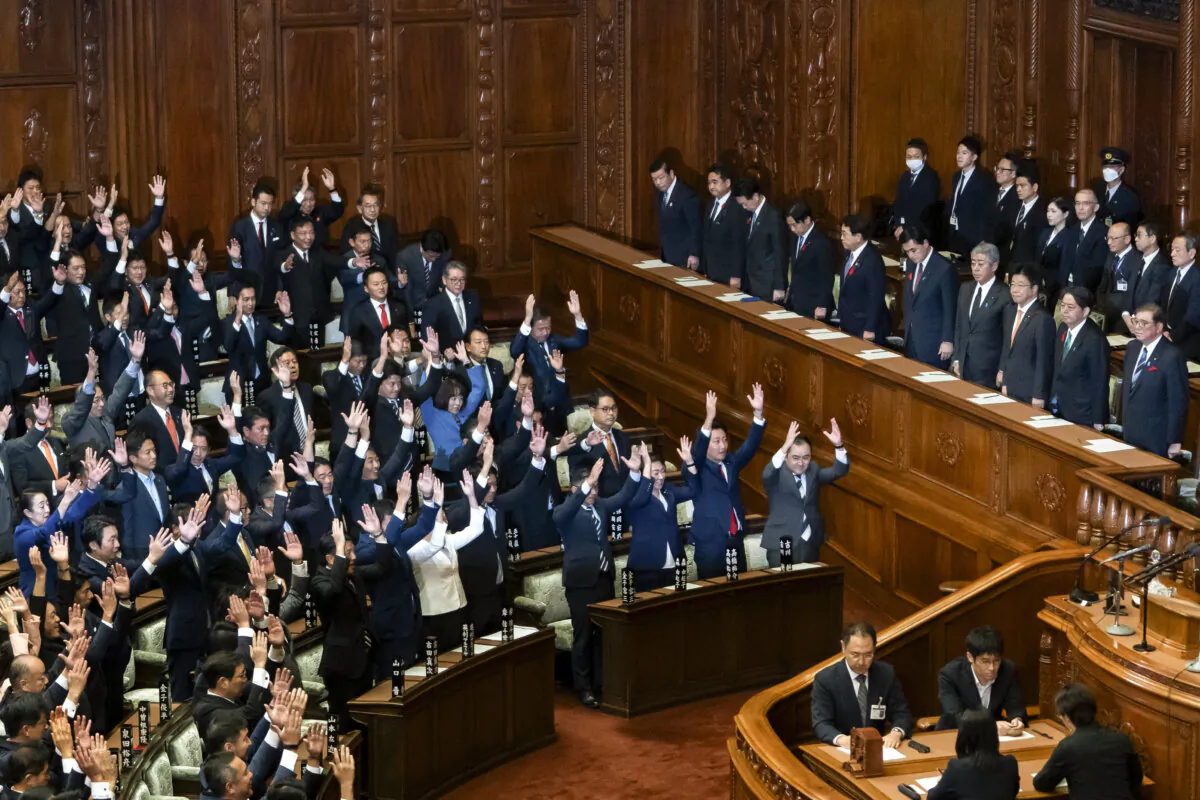 Japanese Prime Minister Shigeru Ishiba (R) stands during a plenary session at the lower house of parliament in Tokyo on Oct. 9, 2024. (Tomohiro Ohsumi/Getty Images)