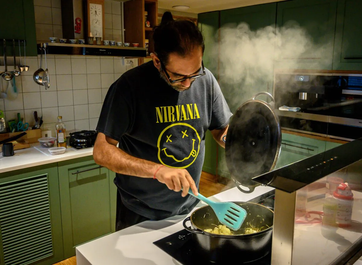 A chef in a Nirvana t-shirt prepares a dish in his home in Bangkok on Aug. 20, 2019. (Mladen Antonov/AFP via Getty Images)