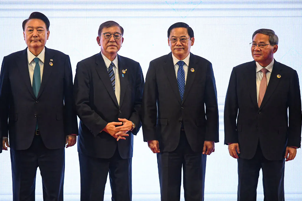 (L-R) South Korea's President Yoon Suk Yeol, Japan's Prime Minister Shigeru Ishiba, Laos' Prime Minister Sonexay Siphandone, and China's Premier Li Qiang stand on stage during a group photo at the 27th ASEAN Plus Three Summit during the 44th and 45th Association of Southeast Asian Nations (ASEAN) Summits in Vientiane on Oct. 10, 2024. (Nhac Nguyen / AFP via Getty Images)