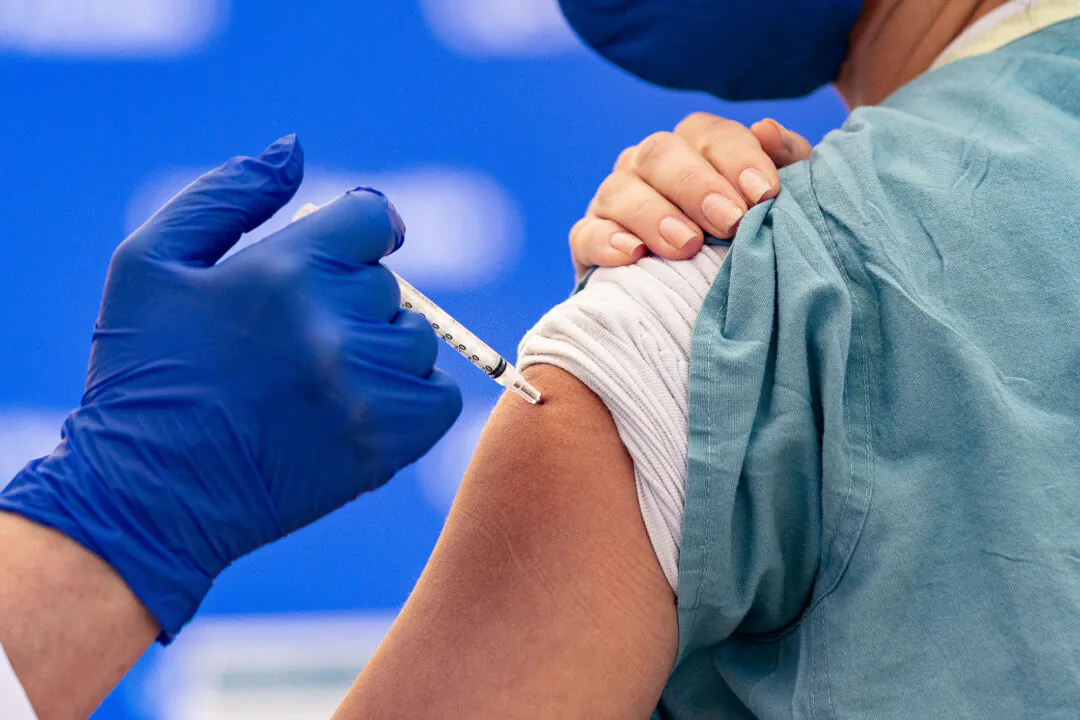 A person receives a COVID-19 vaccine, in a file photograph. (John Fredricks/The Epoch Times)