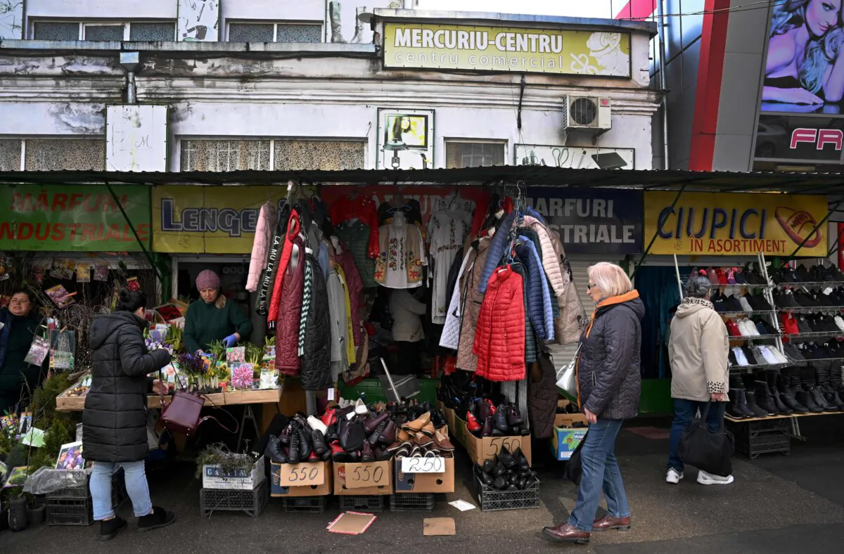 Moldovan customers do shopping at small shops on a street near the Central Market in the capital Chisinau on March 11, 2023. (Daniel Mihailescu/AFP via Getty Images)