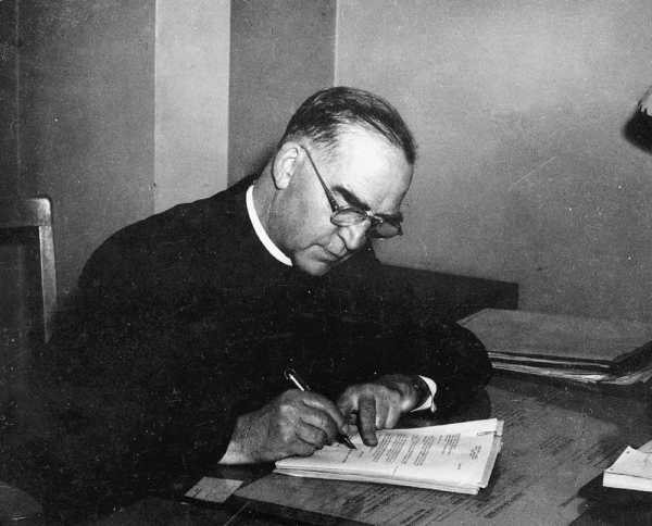 Priest in study in "Heart of a Servant - The Father Flanagan Story." (Spirit Juice Studios)
