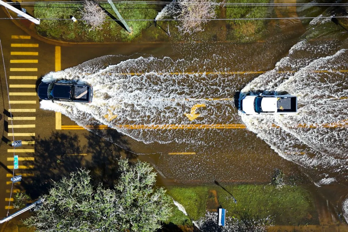 Vehicles drive through flood waters in the aftermath of Hurricane Milton in Lake Maggiore, Fla., on Oct. 10, 2024. (Miguel J. Rodriguez/AFP via Getty Images)