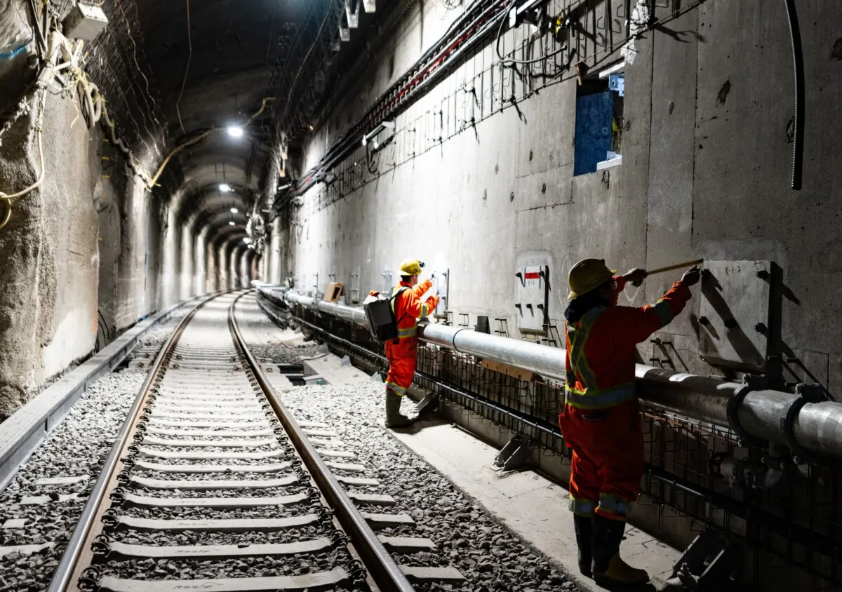 Workers inspect walls in the Mount Royal tunnel as construction progresses for an electric light rail system in Montreal, on May 1, 2024. (The Canadian Press/Christinne Muschi)