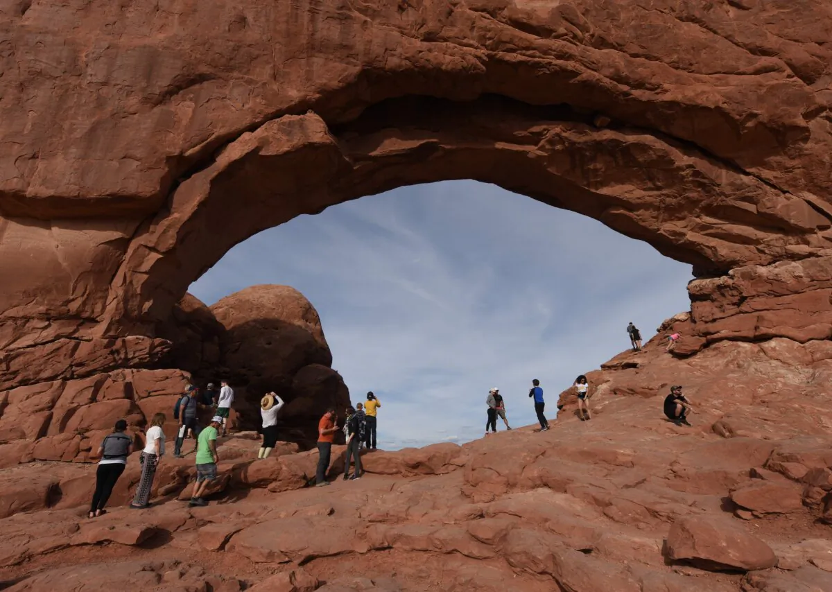 Tourists at the North Window Arch at sunset in the Arches National Park near Moab, Utah, on April 22, 2018.  (Mark Ralston/AFP via Getty Images)
