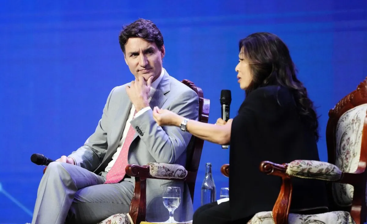Prime Minister Justin Trudeau listens to International Trade Minister Mary Ng during an armchair discussion at the ASEAN business and investment summit Vientiane, Laos, on Oct. 11, 2024 in . (The Canadian Press/Adrian Wyld)