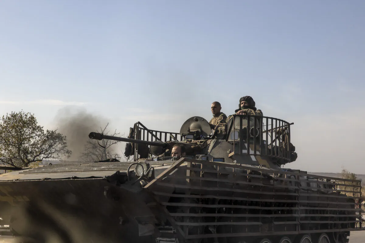 TOPSHOT - Ukrainian servicemen ride a tank on a road in the Donetsk region, on October 12, 2024, amid the Russian invasion on Ukraine. (Photo by Roman PILIPEY / AFP) (Photo by ROMAN PILIPEY/AFP via Getty Images)