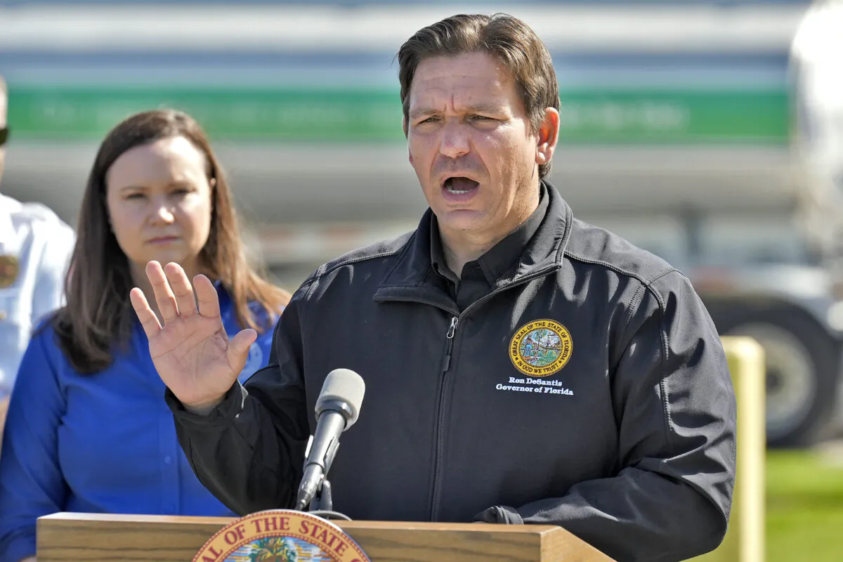 Florida Gov. Ron DeSantis, accompanied by Florida Attorney General Ashley Moody, holds a news conference at a fuel depot in Plant City, Fla., on Oct. 12, 2024. (AP Photo/Chris O'Meara)
